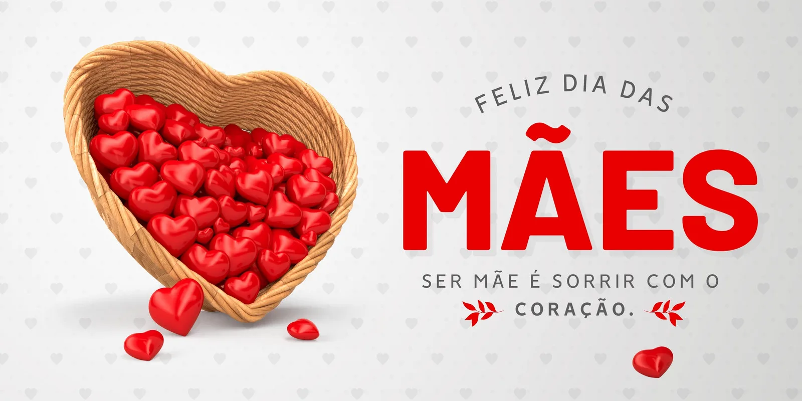 Banner horizontal com a frase "Feliz Dia das Mães" em destaque. Um cesto em formato de coração transborda corações vermelhos, simbolizando amor e carinho. A mensagem "Ser mãe é sorrir com o coração" complementa a arte.